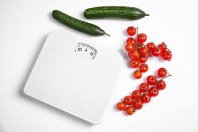 Composition with scales and vegetables on white background, top view