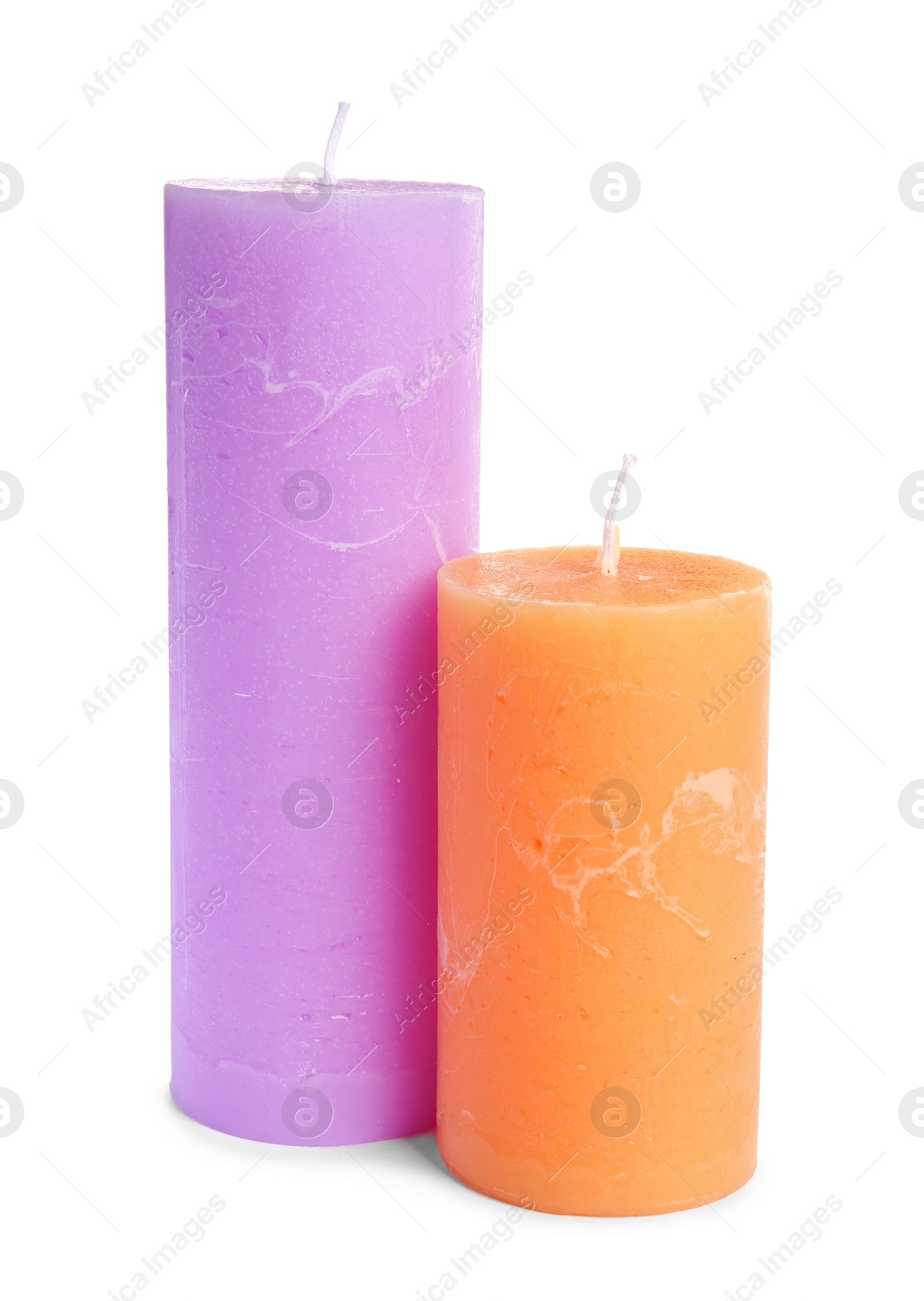 Photo of Two decorative wax candles on white background