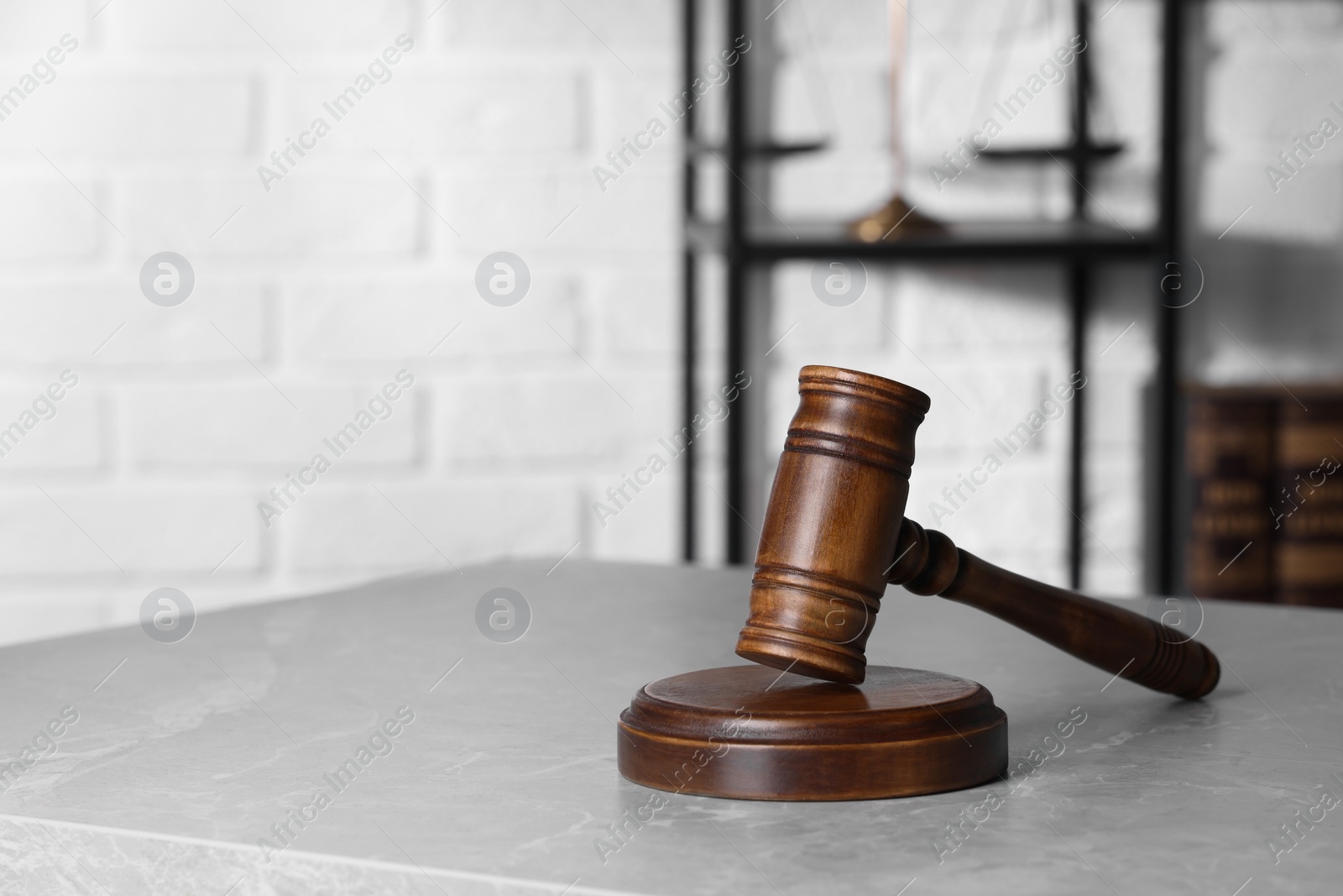 Photo of Law concept. Judge's gavel on light grey marble table indoors, space for text