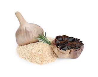 Photo of Heap of dehydrated garlic granules and fermented black garlic isolated on white