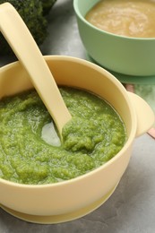 Healthy baby food. Different tasty puree in bowls on light grey table, closeup