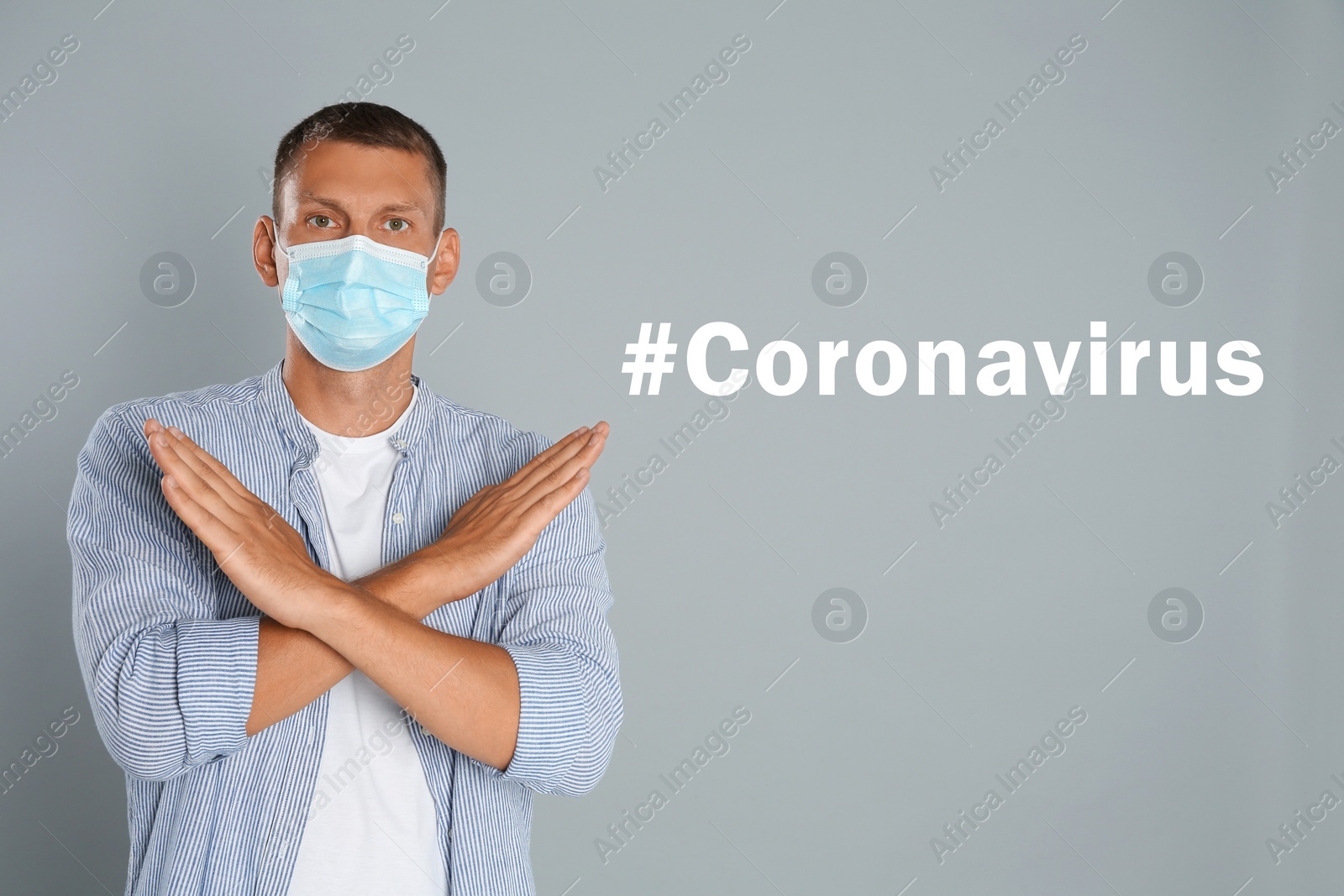Image of Man in protective mask showing stop gesture near hashtag Coronavirus on grey background