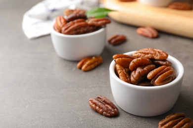 Photo of Small dish with tasty pecan nuts served on table. Space for text