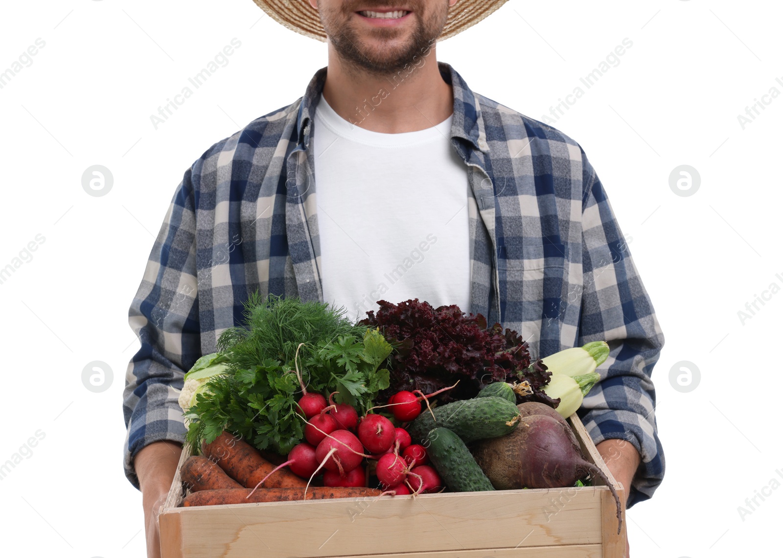 Photo of Harvesting season. Happy farmer holding wooden crate with vegetables on white background, closeup