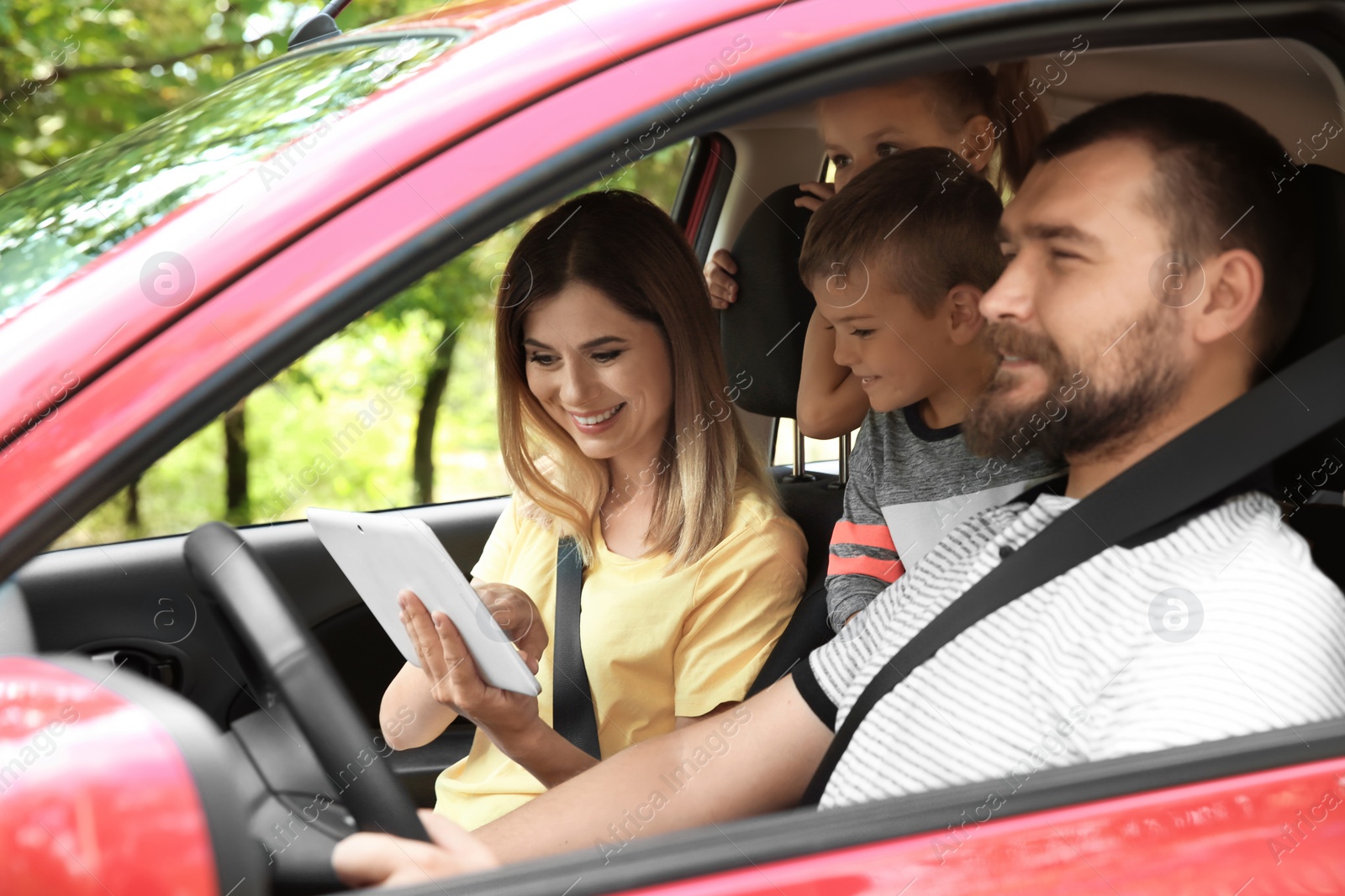 Photo of Happy family with children taking road trip together