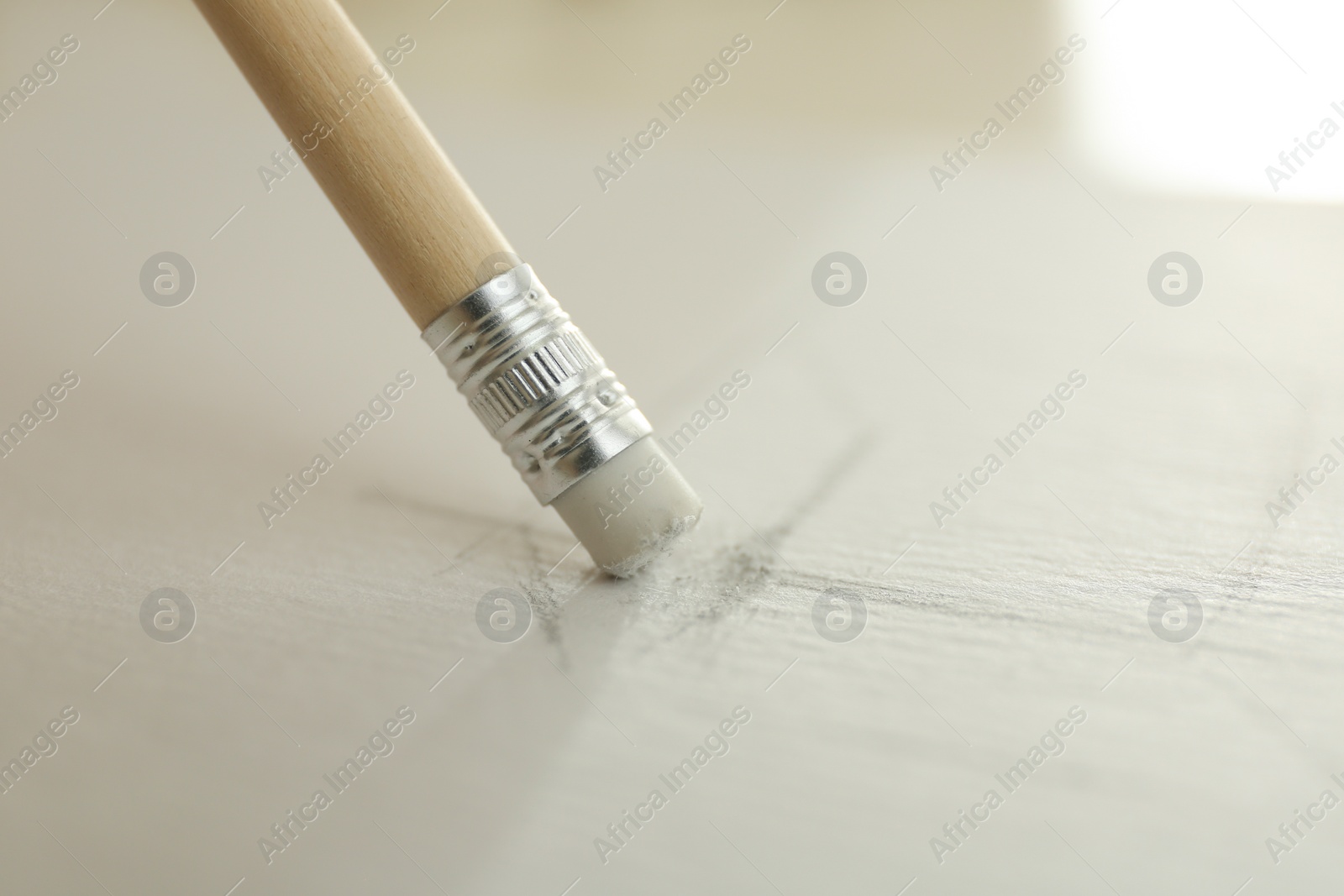 Photo of Correcting picture on paper with pencil eraser, closeup view