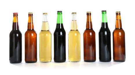 Bottles with different beer on white background