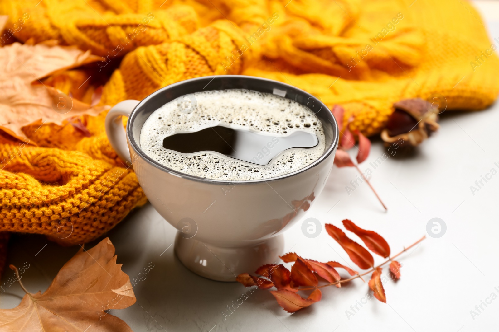 Photo of Composition with hot drink and warm plaid on light table