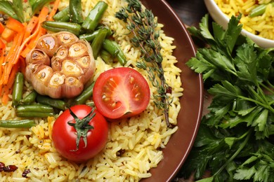 Photo of Tasty rice pilaf with vegetables on table, closeup