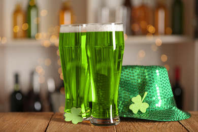 Green beer, clover and hat on wooden counter. St.Patrick's Day celebration