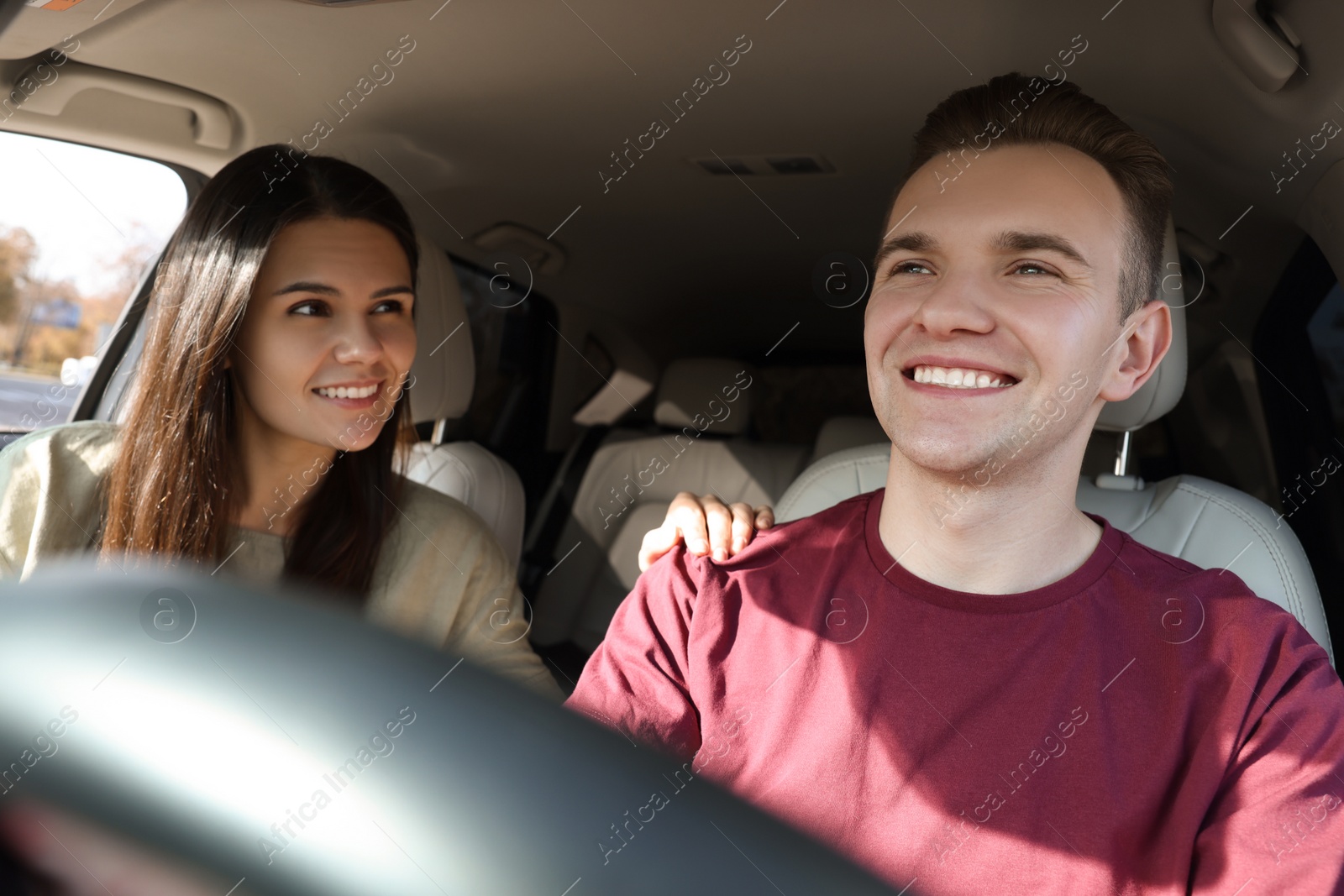 Photo of Happy young couple travelling together by car