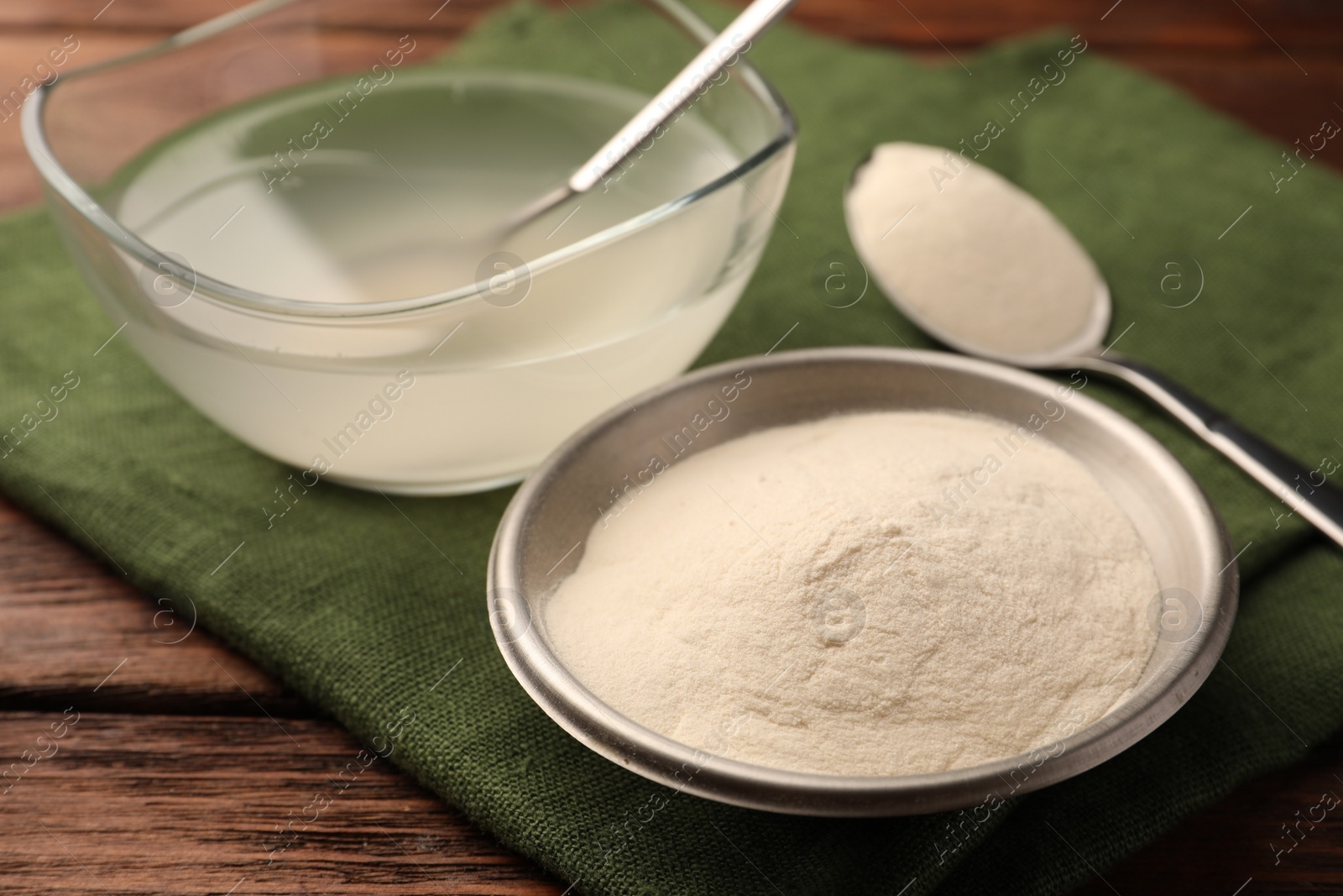 Photo of Agar-agar jelly and powder on wooden table, closeup