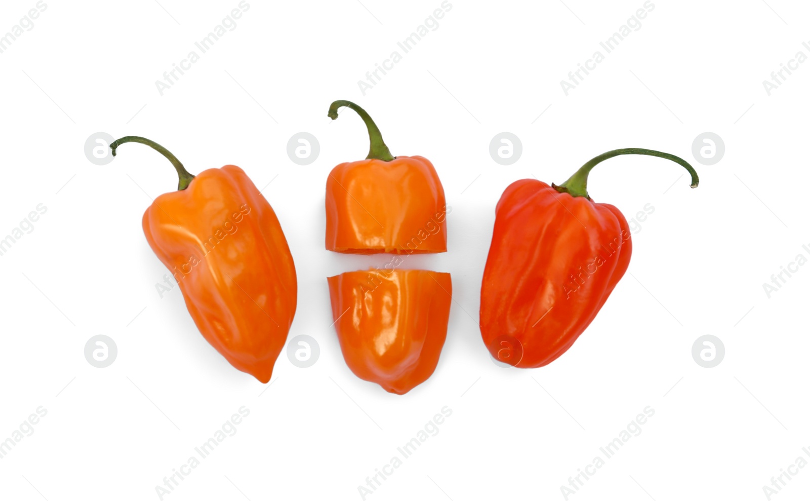 Photo of Whole and cut hot chili peppers on white background, flat lay