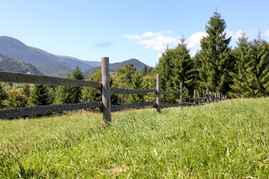 Photo of Beautiful view of mountain countryside with wooden fence