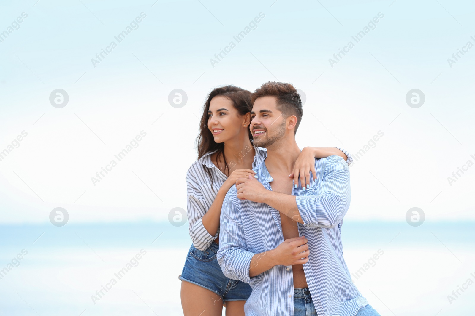 Photo of Happy young couple spending time together on beach