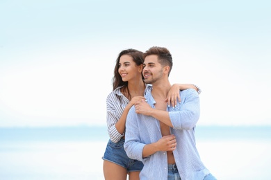 Happy young couple spending time together on beach