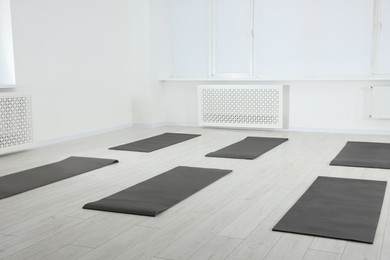 Photo of Spacious yoga studio with exercise mats on floor