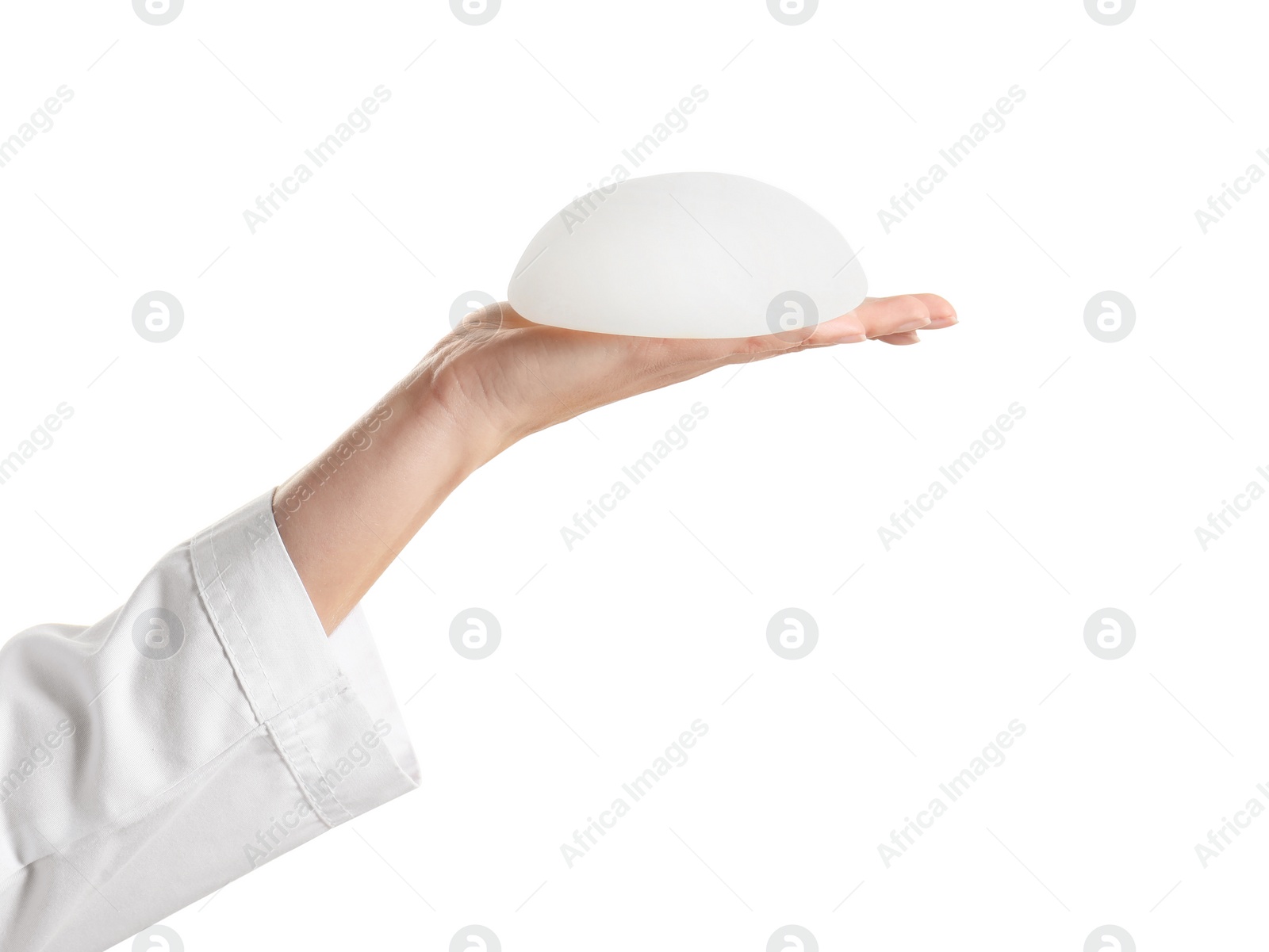 Photo of Doctor holding silicone implant for breast augmentation on white background. Cosmetic surgery