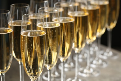 Many glasses of champagne on table, closeup