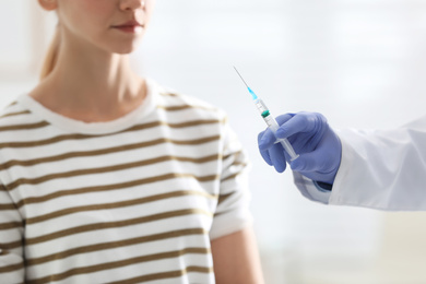 Photo of Doctor giving injection to patient in hospital, closeup. Vaccination concept