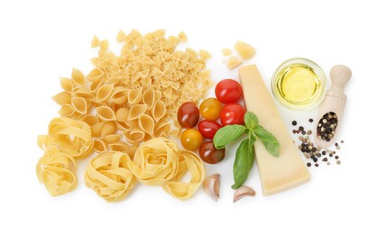 Different types of pasta and ingredients on white background, top view