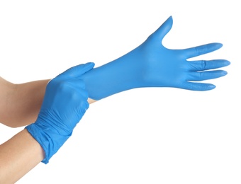Photo of Woman putting on blue latex gloves against white background, closeup of hands