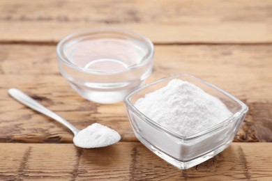 Photo of Bowls of fructose syrup and powder on wooden table