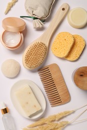 Photo of Bath accessories. Different personal care products and dry spikelets on white background, flat lay