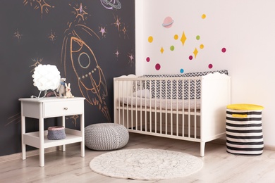 Stylish baby room interior with comfortable bed