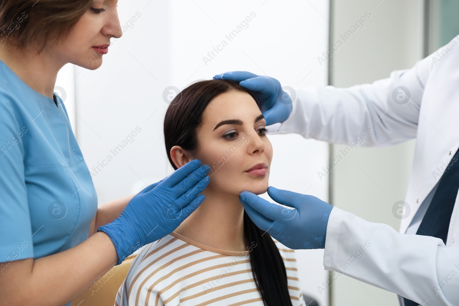 Photo of Professional doctors examining patient before surgery in clinic