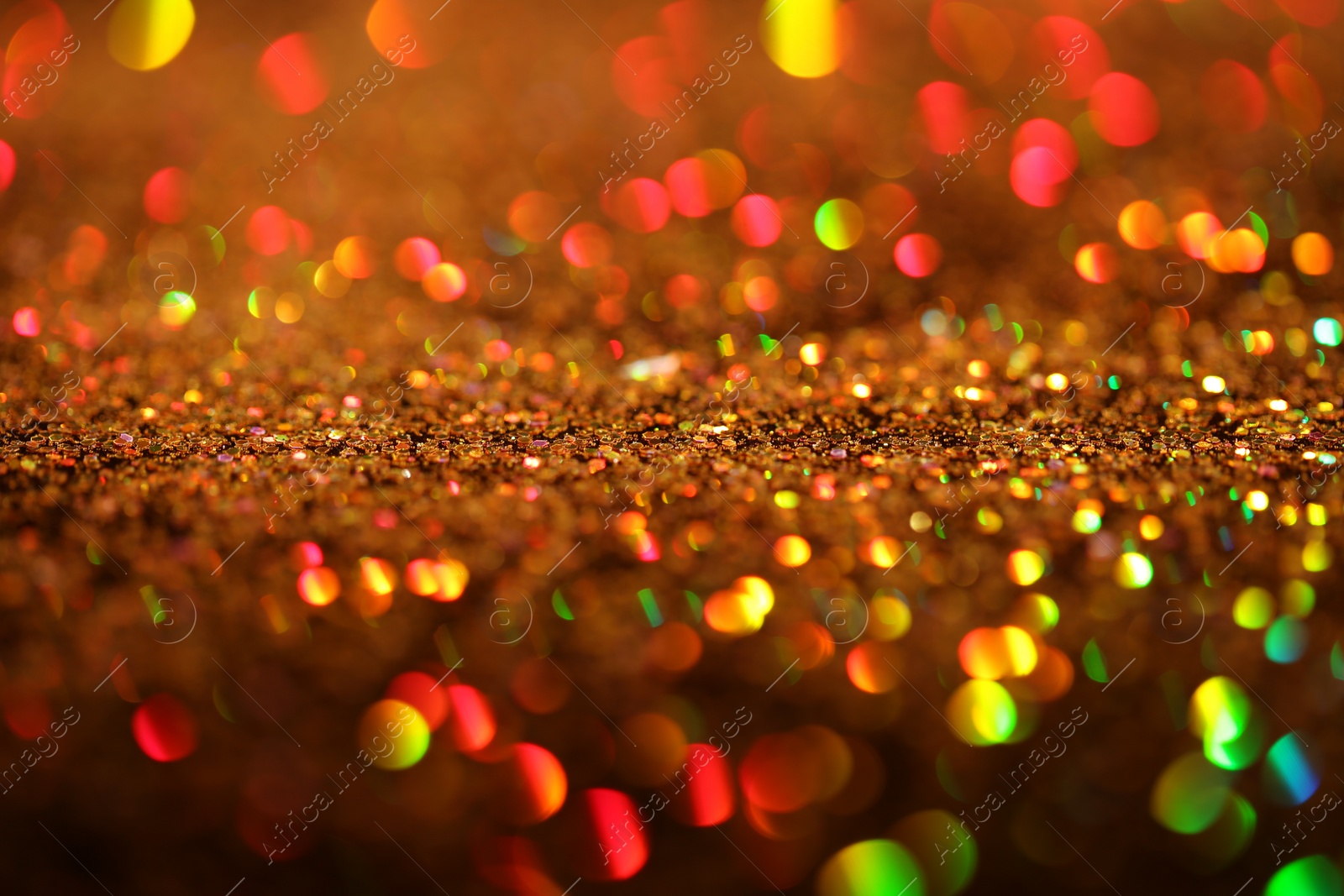 Photo of Shiny golden glitter as background, closeup view