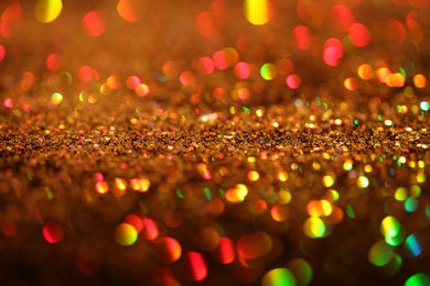 Shiny golden glitter as background, closeup view