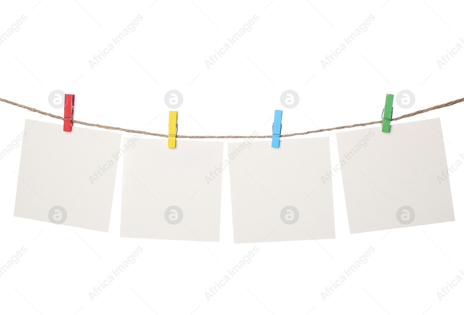 Photo of Clothespins with empty notepapers on string against white background. Space for text