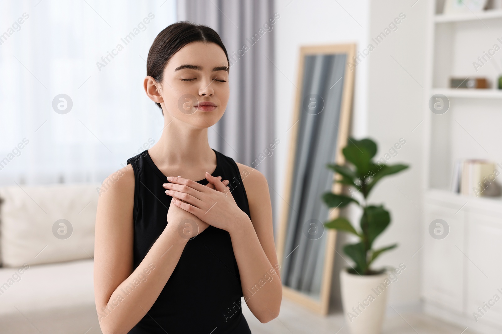 Photo of Beautiful girl meditating at home. Practicing yoga