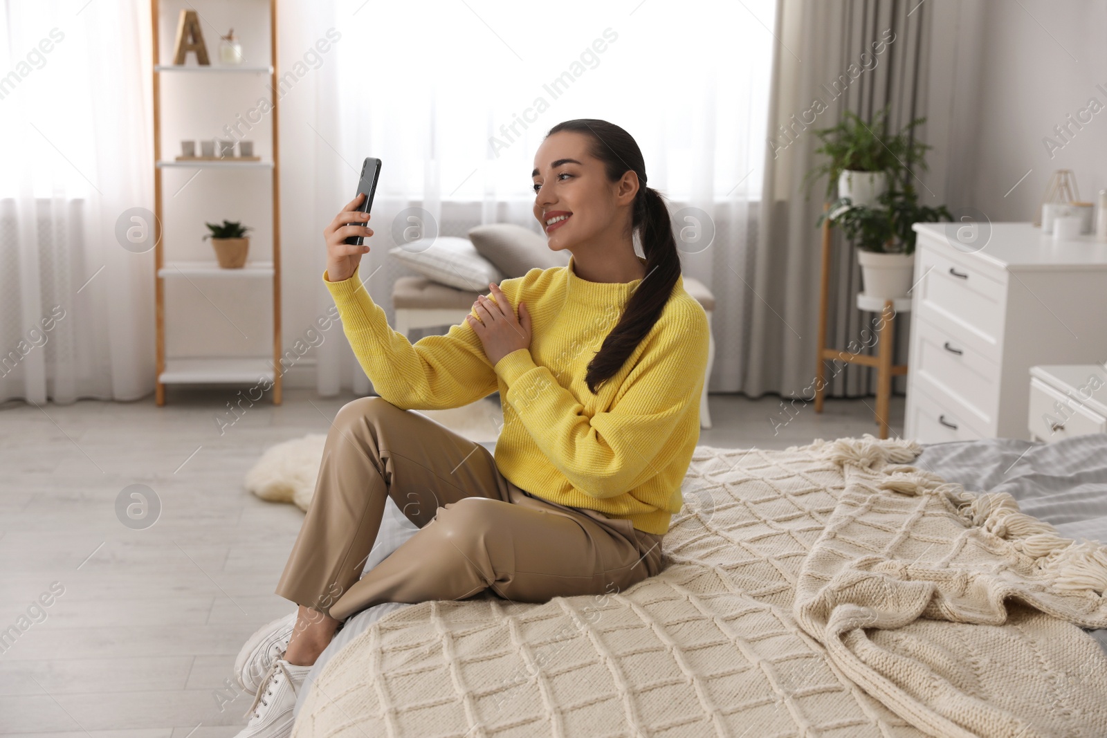 Photo of Young woman taking selfie at home in morning