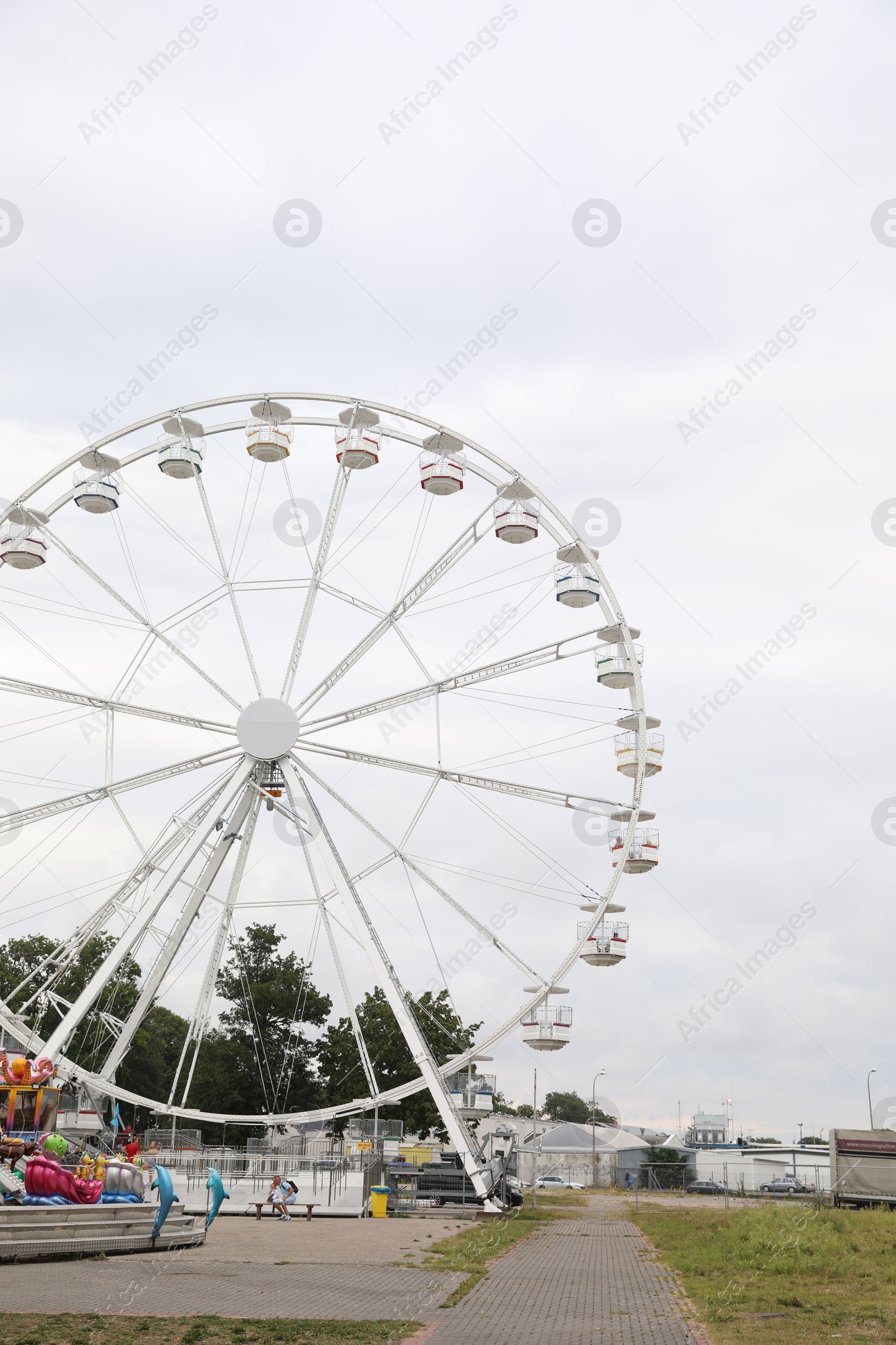 Photo of DARLOWO, POLAND - AUGUST 22, 2022: Large white observation wheel in amusement park