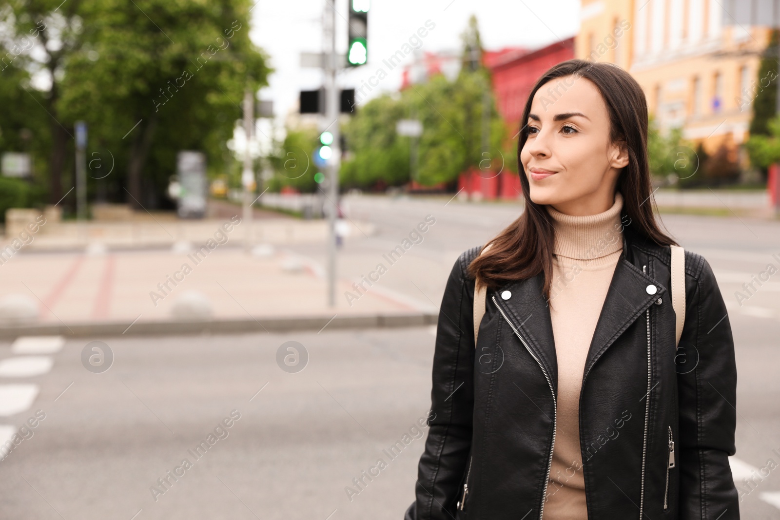Photo of Young woman crossing street. Traffic rules and regulations
