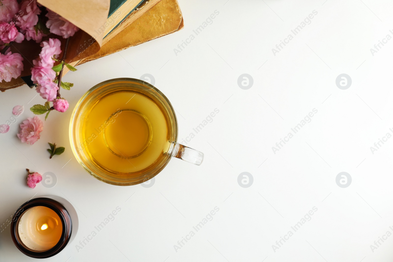 Photo of Flat lay composition with cup of freshly brewed tea on light table. Space for text