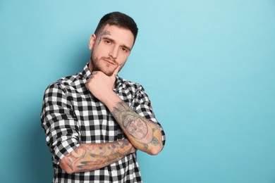 Photo of Portraithandsome hipster man on light blue background. Space for text