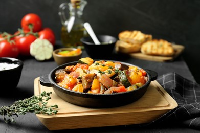 Dish with tasty ratatouille on black table