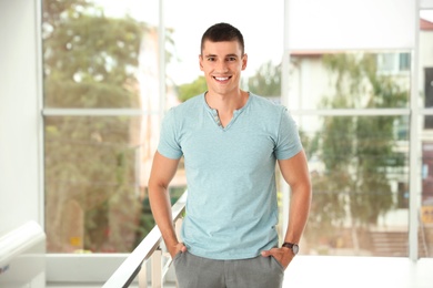 Photo of Portrait of handsome young man standing indoors