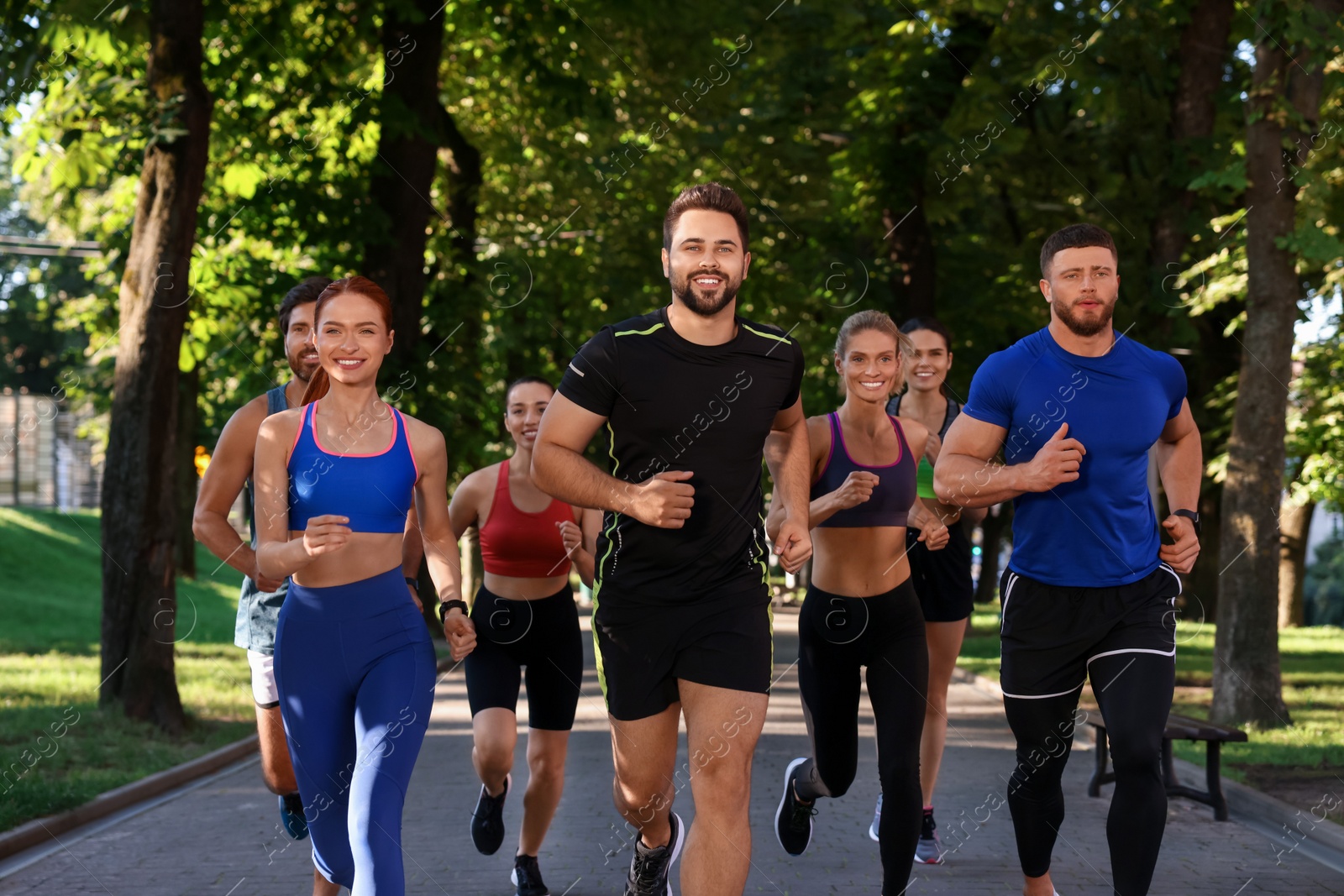 Photo of Group of people running in park. Active lifestyle