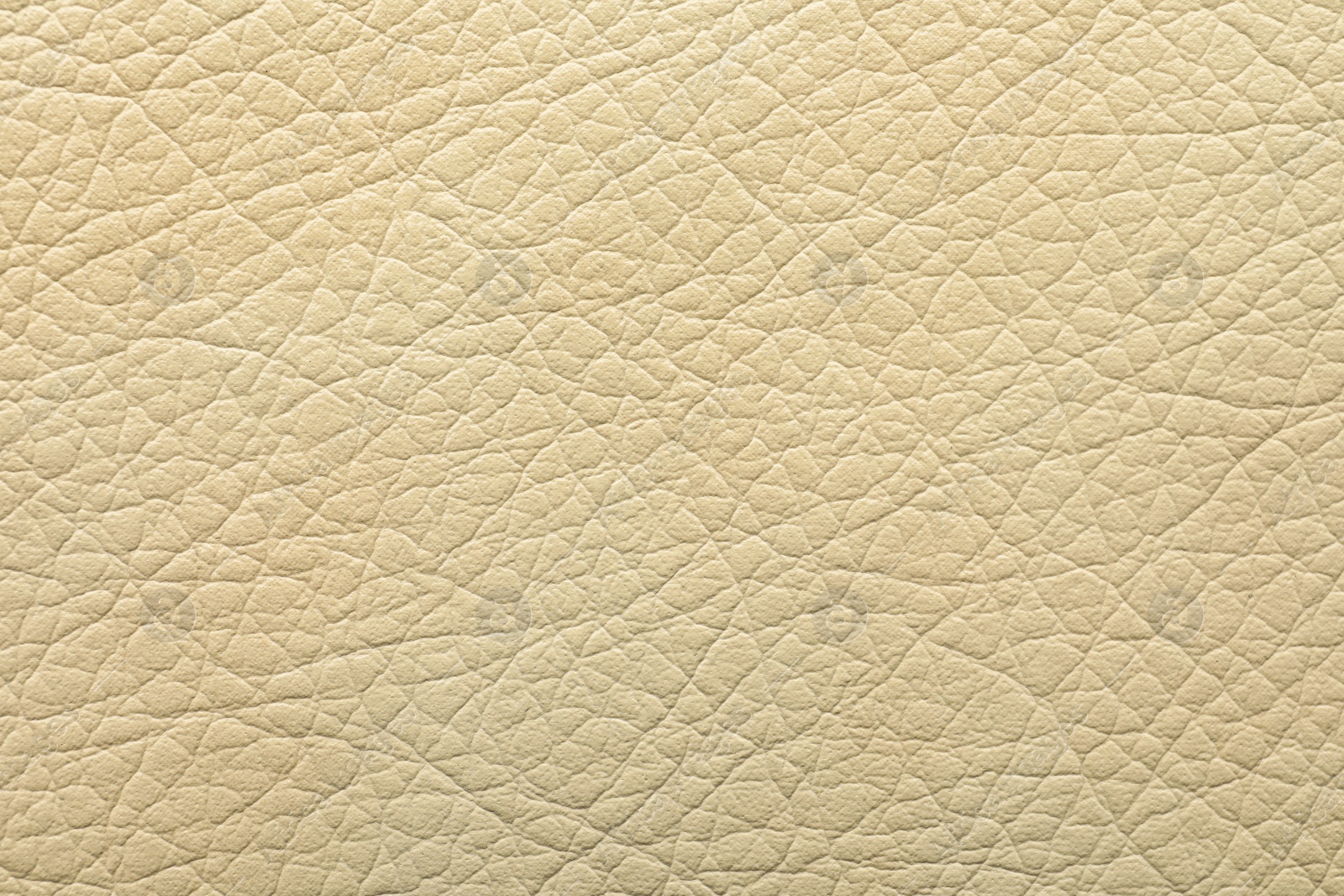 Photo of Texture of beige leather as background, closeup