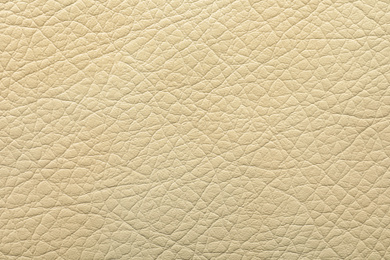 Photo of Texture of beige leather as background, closeup