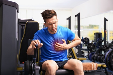 Photo of Young man having heart attack in gym