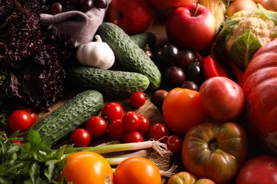 Photo of Different fresh ripe vegetables and fruits on wooden table, above view