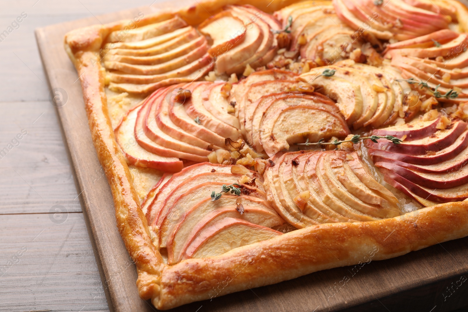 Photo of Freshly baked apple pie with nuts on table, closeup