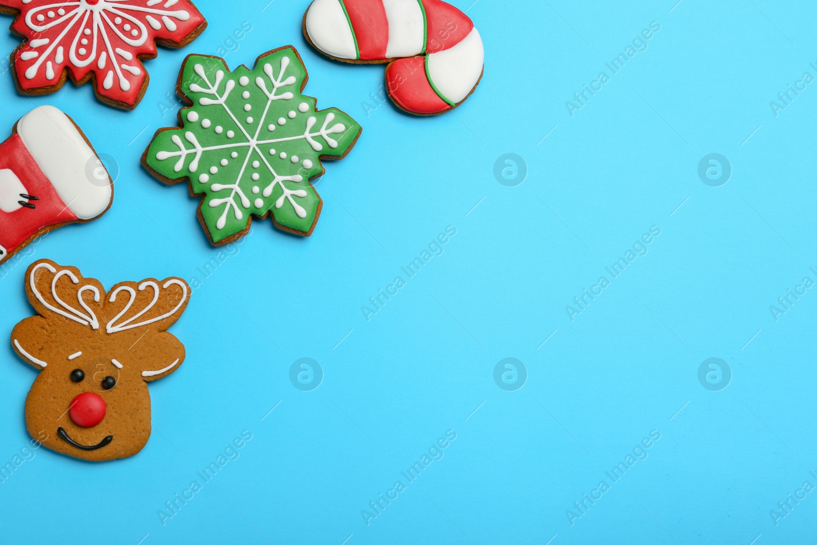 Photo of Different tasty Christmas cookies on light blue background, flat lay. Space for text