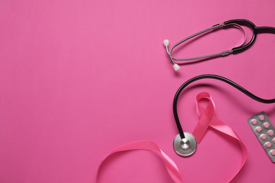Photo of Pink ribbon on color background, top view and space for text. Breast cancer awareness