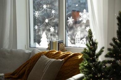 Beautiful drawing made of artificial snow on window at home. Christmas decor